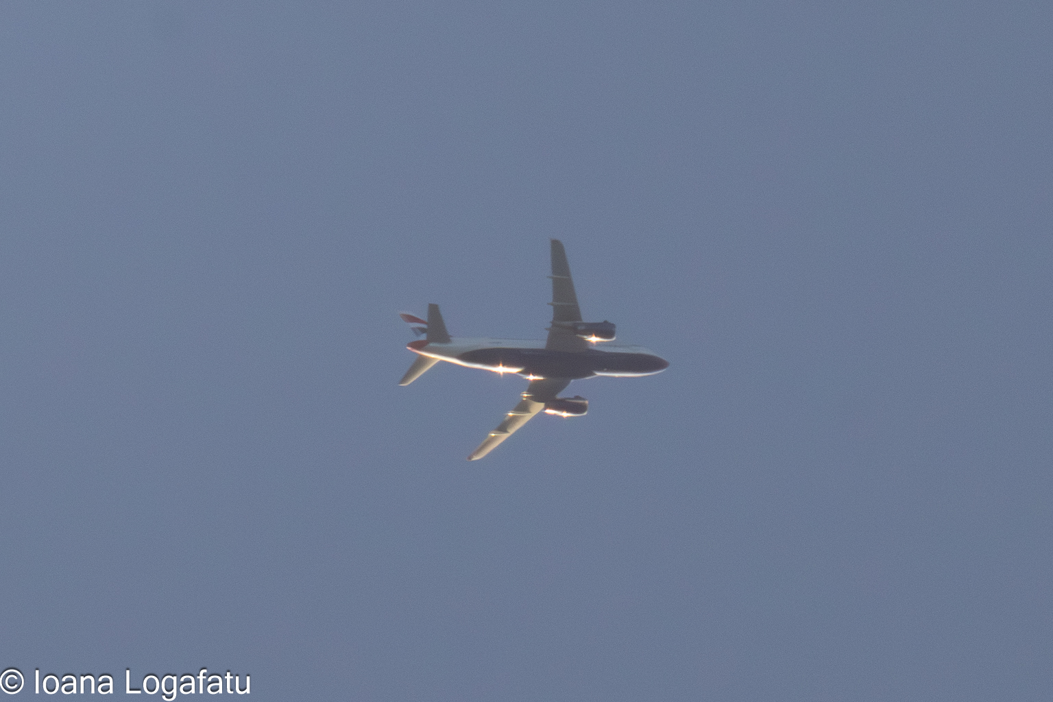 Airplane soaring in the clear blue sky above